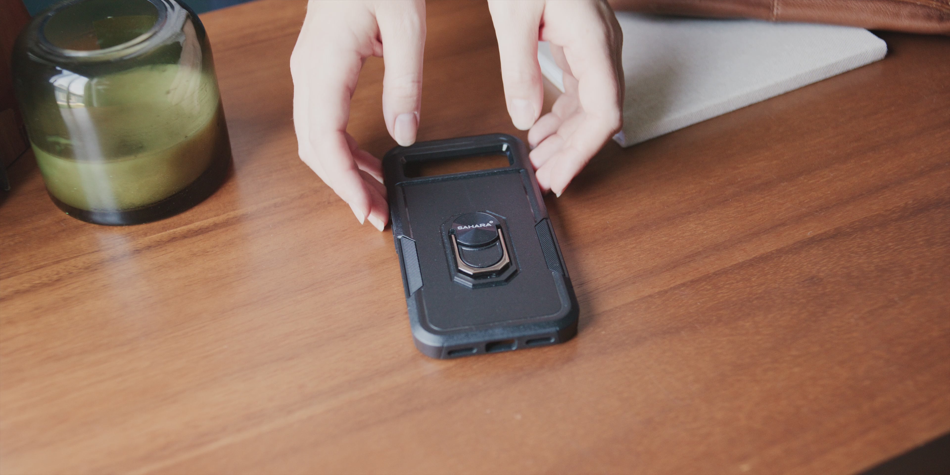 SaharaCase heavy-duty shockproof phone case with protective bumpers and kickstand.